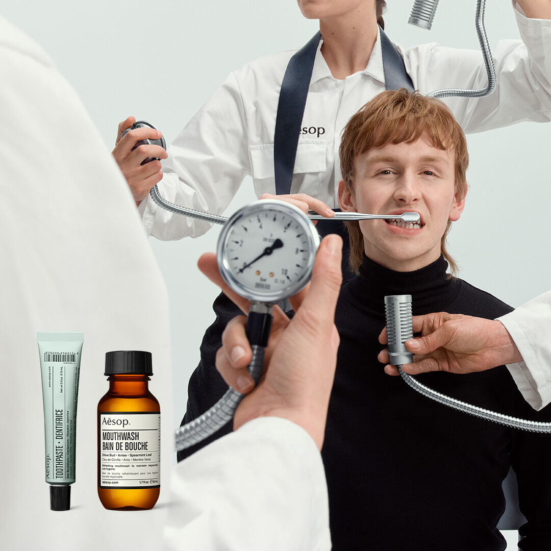 Surreal clinical oral care scene featuring Aesop products.